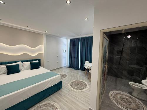 a hotel room with a bed and a bathroom at Holiday Home in Shkodër