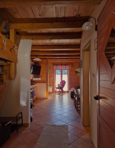 a living room with a wooden ceiling and a hallway at Holiday Home Brist in Brestova Draga