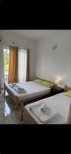 a bedroom with two beds with towels on them at Long Beach Truma in Ulcinj