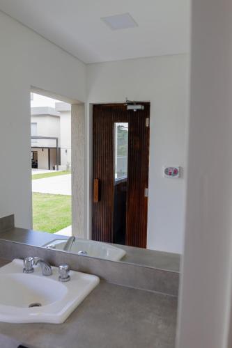 a bathroom with a sink and a mirror at Almería Suites in Salta