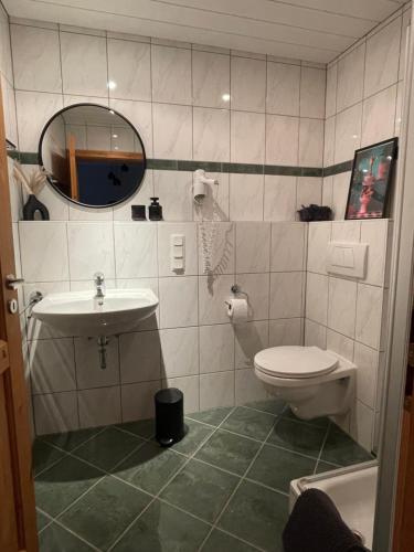 a bathroom with a toilet and a sink at Ferienwohnung Haus Liane in Reil