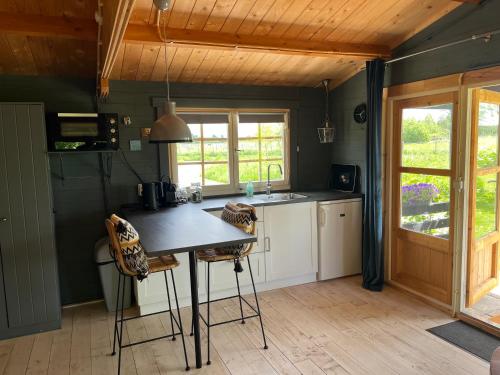 a kitchen with a table and chairs in a room at Fields 1216 in Zwaanshoek
