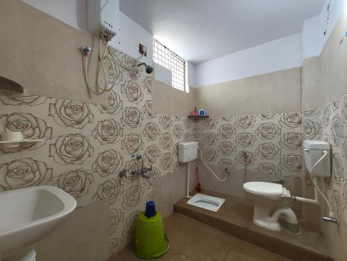 a bathroom with a toilet and a sink at Galaxy Homestay 4Bhk AC in Mysore