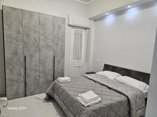 a bedroom with a bed with towels on it at Residence Niko 5 Pomezia in Pratica di Mare