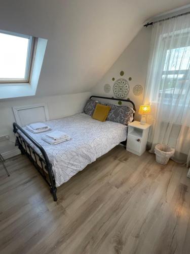 a bedroom with a bed with a wooden floor at Wild Atlantic View in Walshestown