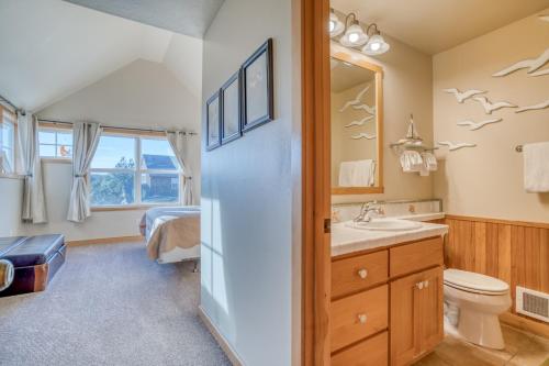 a bathroom with a toilet and a sink at A Mermaids Dream in Pacific City