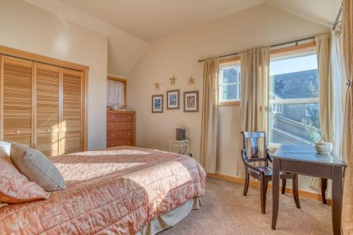 a bedroom with a bed and a desk and a window at A Mermaids Dream in Pacific City