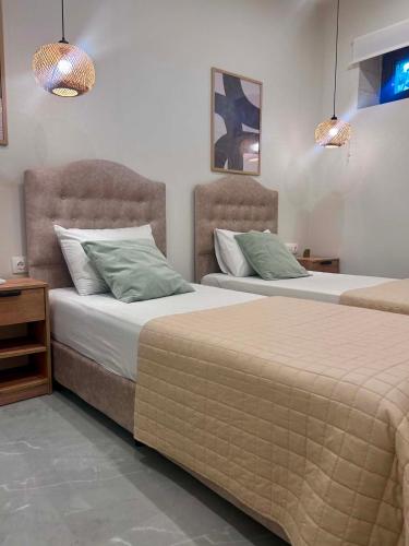 two beds sitting next to each other in a bedroom at Stone Luxury Suite in Galatás