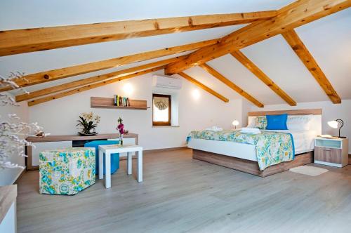 a bedroom with a bed and a desk in a room at Villa Masi in Kanfanar