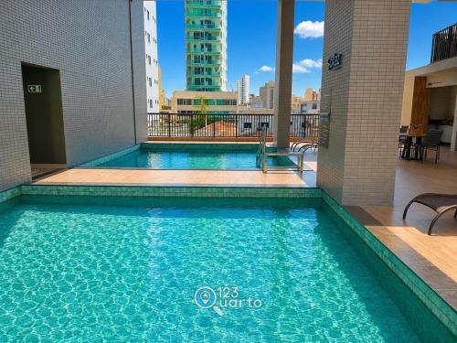 a swimming pool with a view of the city at Solaz Smart Living by 123Quarto in Tambaú