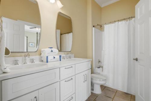 a bathroom with a sink and a toilet and a mirror at USA II in Gulf Shores