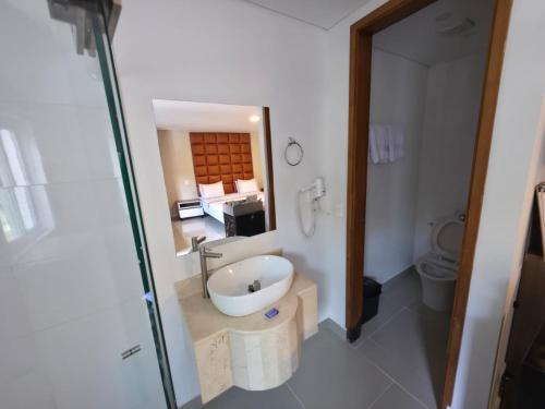 a bathroom with a sink and a toilet at Infinity Hotel in Medellín