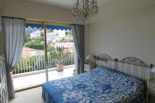a bedroom with a bed and a large window at La Reale in Villefranche-sur-Mer