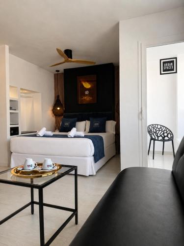a hotel room with a bed and a table in a room at Urban Spaces Ibiza in Ibiza Town