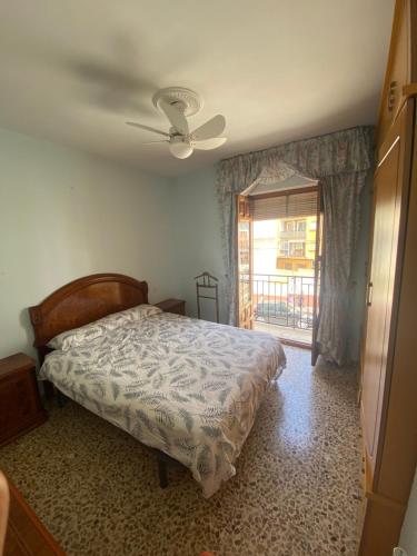 a bedroom with a bed and a ceiling fan at Casa Magdalena in Archidona