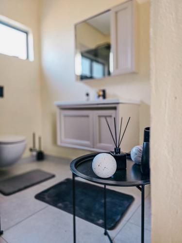 a room with a table with a sink and a mirror at Orang Cottages BW in Ramotswa