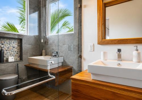 a bathroom with a sink and a mirror at Alma de Ojochal in Ojochal