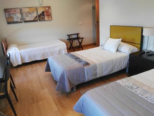 Voodi või voodid majutusasutuse Hotel Santa Ana toas