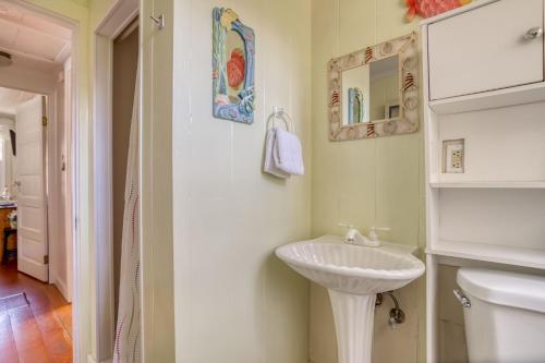 a white bathroom with a sink and a toilet at Cathys Cottage in Cannon Beach