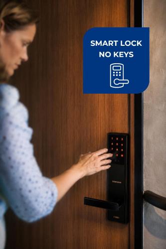a woman unlocking a door with a smart lock no keys at Live Soho Boutique Hotel & Apartments in Buenos Aires