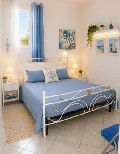 a bedroom with a bed with a blue comforter at Villa Florence apartment con parcheggio in Torre Lapillo