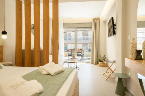 a bedroom with a bed and a dining room at MarAzul Luxury Suites in Flogita