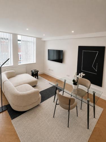 a living room with a couch and a table and chairs at Parkway House in Chelmsford
