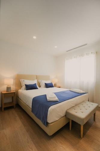 a bedroom with a large bed and a window at Villa d'Avó Dalva in Vila Chã