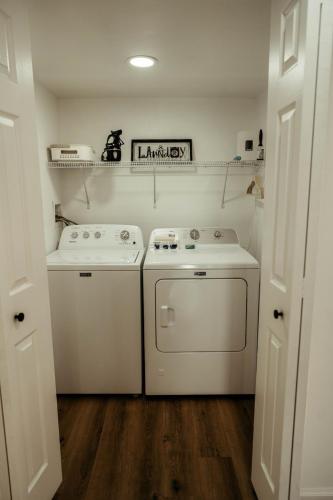 a kitchen with a stove and a washer and dryer at Arminta Street Retreat in DuBois