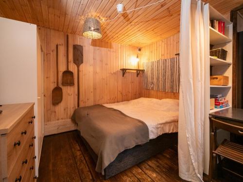 a bedroom with a bed in a wooden room at Leśna Chata in Bierzów