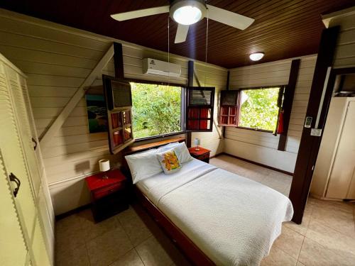 a bedroom with a bed and two windows at Annes Retreat in Castries