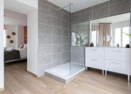 a bathroom with a shower with a sink and a mirror at Maison chic avec Psicine - Talant proche Prenois in Talant