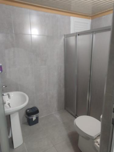 a bathroom with a shower and a toilet and a sink at Anatolia Hotel in Pamukkale