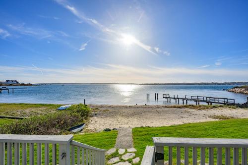 a view of a beach with a white fence at Cape Cod Waterfront with Stunning Views in Buzzards Bay