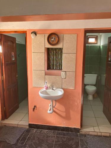 a bathroom with a sink and a toilet at HOSTAL LUCERO in Humahuaca