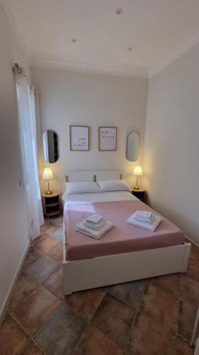 a bedroom with a bed with two towels on it at DIMORA REALE - Charming House Caserta in Casagiove
