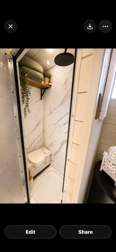 a small bathroom with a shower with a toilet at The Stallion in Sturminster Newton
