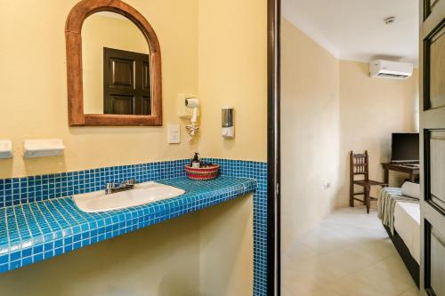 a bathroom with a sink and a mirror at Hotel Barrio Latino in Playa del Carmen