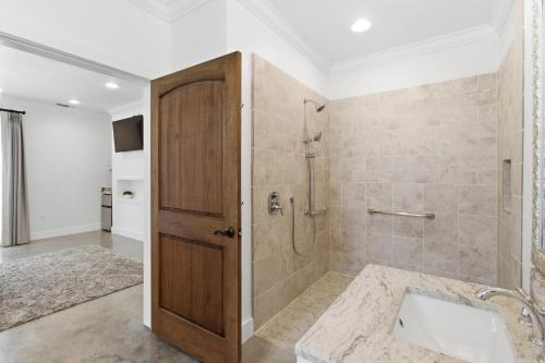 a bathroom with a shower and a tub with a sink at Emigrant's Inn in Fredericksburg