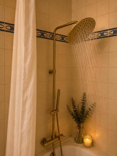 a bathroom with a shower with a shower curtain at Refúgio No16 Ocean Air & Rooftop Flair in Albufeira