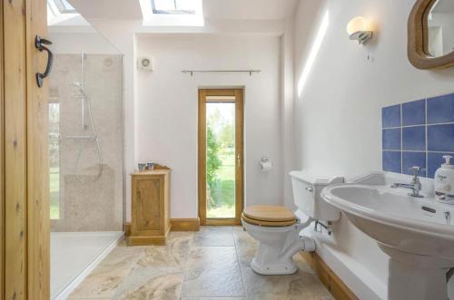 a bathroom with a toilet and a sink and a shower at 1 Bed in Broadway oc-36842 in Broadway