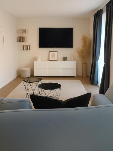 a living room with a couch and a tv at PepinA'S Home in Martigny-Ville