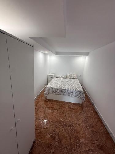 a bedroom with a bed in the middle of a room at Casa Tul Studio Apartment in Maspalomas