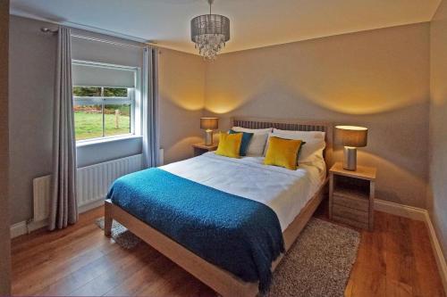 a bedroom with a bed with yellow pillows and a window at 4 Bed in Beara oc-i437 in Adrigole