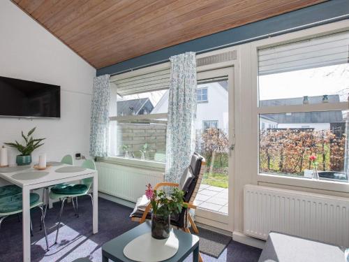 a living room with a table and a window at 4 star holiday home in Væggerløse in Bøtø By