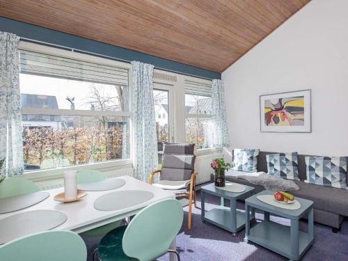a living room with a table and chairs and a window at 4 star holiday home in Væggerløse in Bøtø By