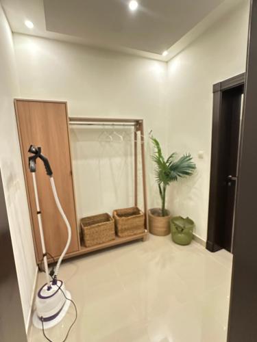 a shower in a bathroom with a plant at Bohovibes in Buraydah