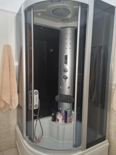 a bathroom with a mirror in the corner of a room at Kalanar villa in Elbasan