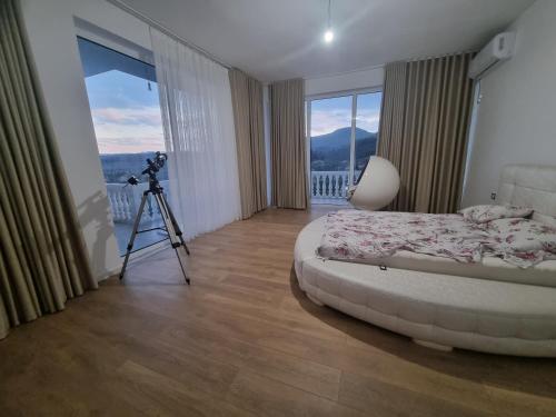 a bedroom with a camera and a bed with a tripod at Kalanar villa in Elbasan