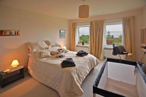 a bedroom with a bed with a teddy bear on it at 3 Bed in Inch oc-i444 in Caheracruttera